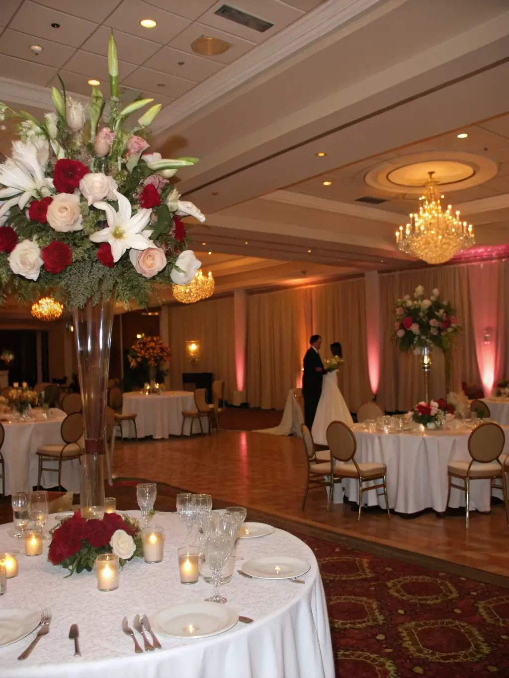 A beautifully decorated wedding reception with elegant floral arrangements and soft lighting, capturing the romance and sophistication of a House of Price wedding.